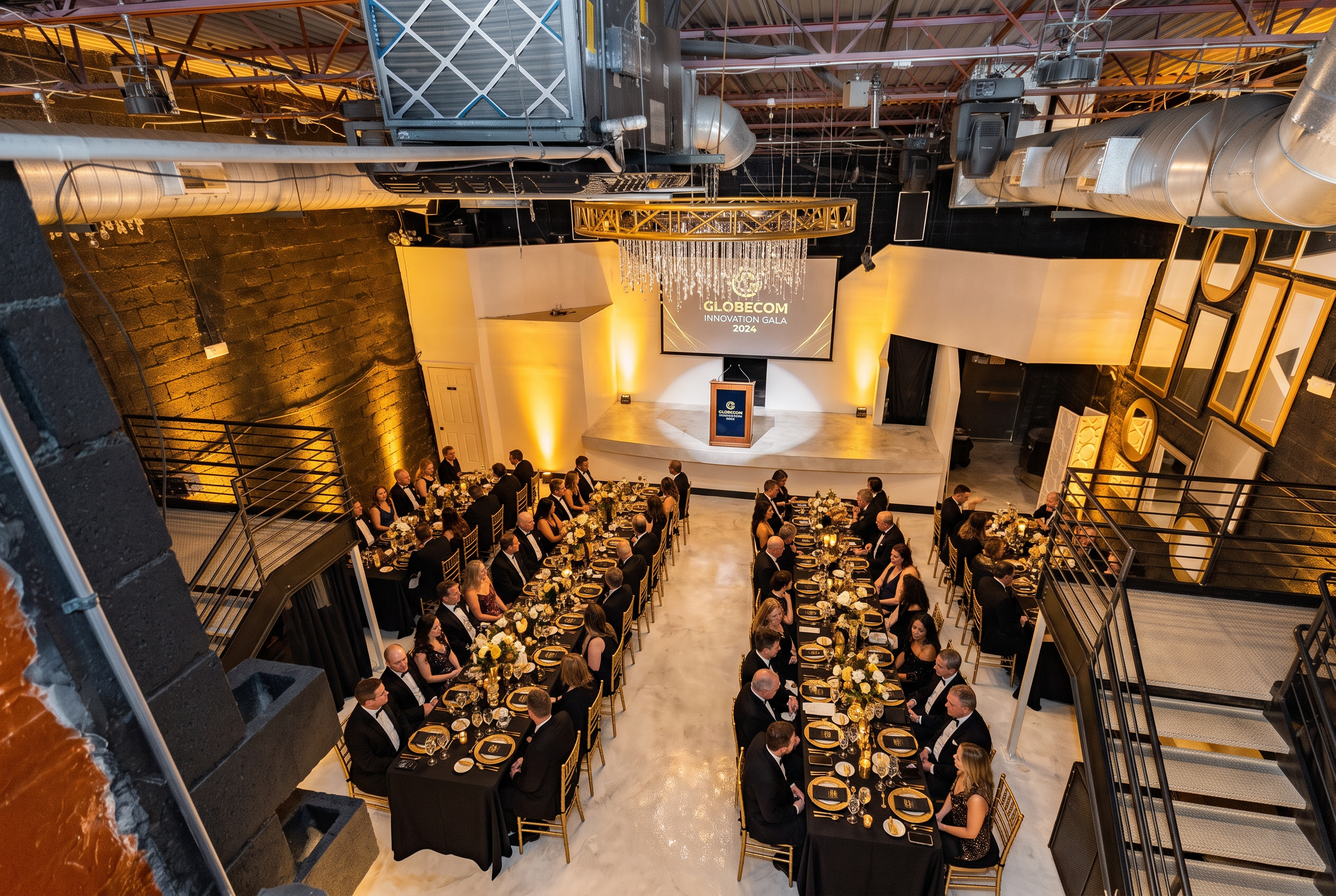 Corporate gala dinner with long banquet tables, stage screen and podium