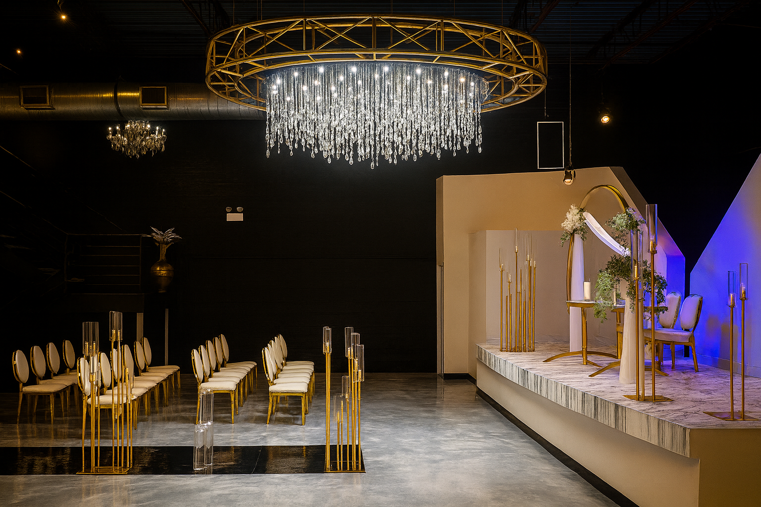 Orchestra Hall set for a wedding ceremony with a crystal chandelier, gold chairs and marble stage